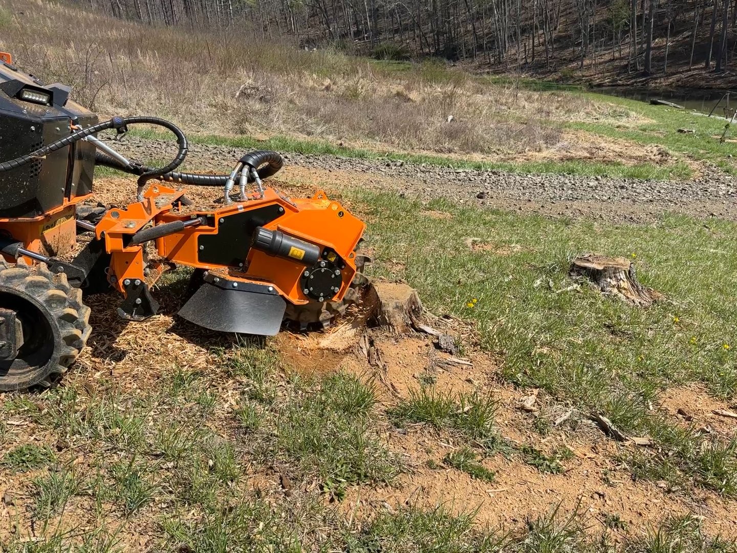 Stump grinder on stump in open field